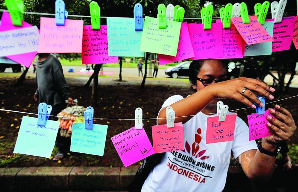Relawan menuliskan pesan antikekerasan saat digelar kampanye One Billion Rising Indonesia di pelataran Monumen Nasional, Jakarta, Kamis (14/2). Kampanye ini merupakan bagian dari gerakan internasional menumbuhkan kesadaran pengurangan kekerasan seksual terhadap perempuan dan anak.