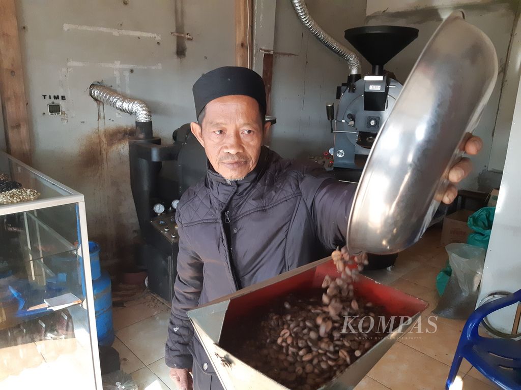 Petani memasukkan biji kopi yang sudah disangrai ke mesin penggiling kopi bubuk di Kecamatan Sekincau, Kabupaten Lampung Barat, Lampung, Kamis (4/7/2024).