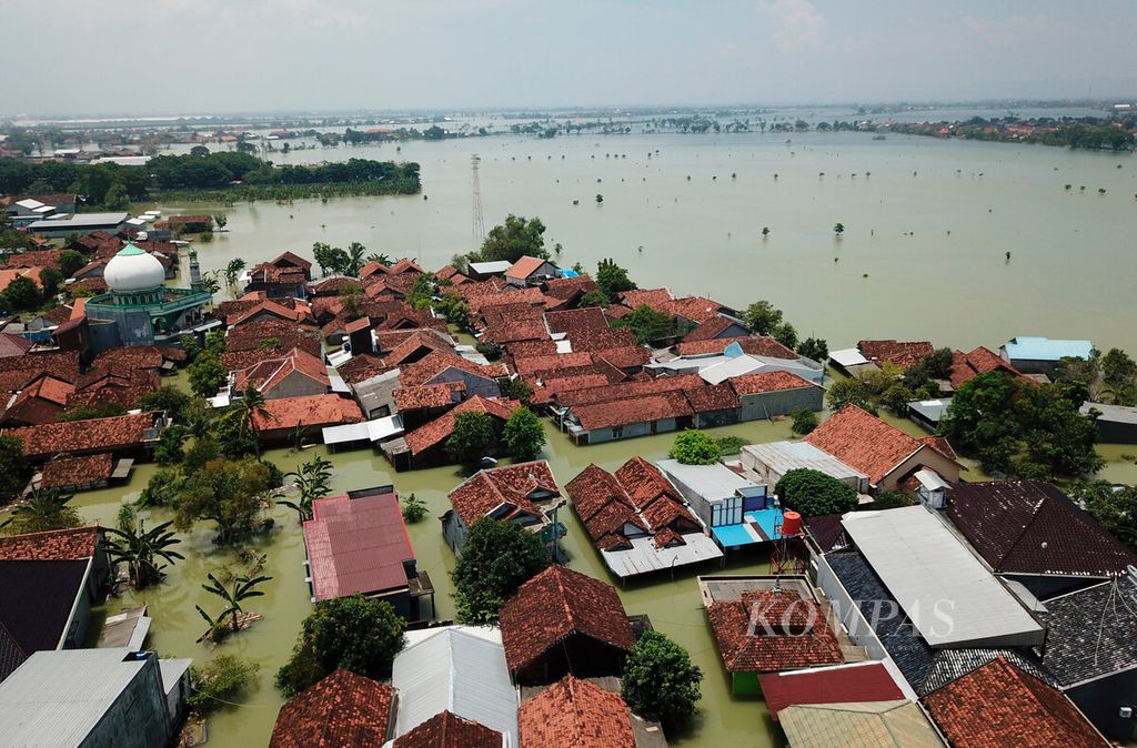 Permukiman warga dengan latar belakang area pertanian yang tenggelam karena banjir beberapa hari ini di Kecamatan Karanganyar, Kabupaten Demak, Jawa Tengah, Selasa (19/3/2024). 