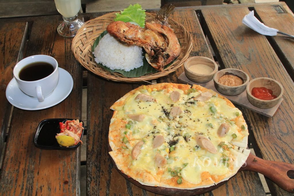 Piza andaliman dengan tiga jenis saus, nila goreng toba, dan teh jahe disajikan untuk pengunjung di Restoran Pizza Andaliman di Kecamatan Balige, Kabupaten Toba, Sumatera Utara, Selasa (19/12/2023).