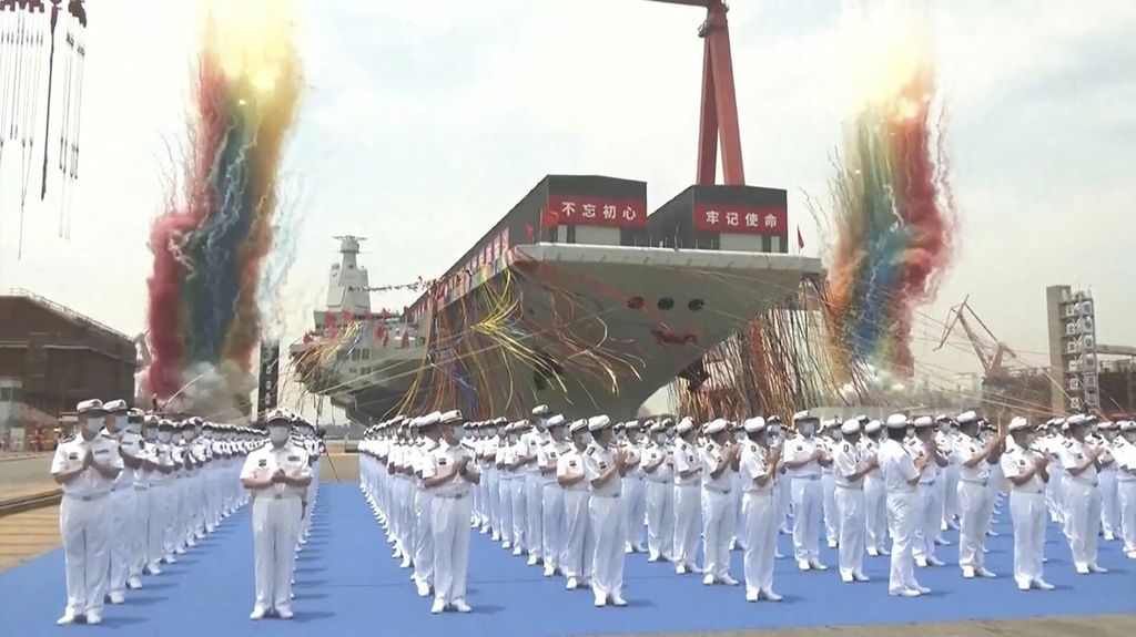 Tangkapan layar yang diambil dari video yang dirilis oleh lembaga penyiaran China, CCTV, menunjukkan upacara peluncuran Fujian, kapal induk Tentara Pembebasan Rakyat (PLA), di galangan kapal di Shanghai pada 17 Juni 2022.  China meluncurkan kapal induk ketigan, yang dirancang dan dibangun seluruhnya di negara ini, menandai kemajuan militer besar bagi negara adidaya Asia.