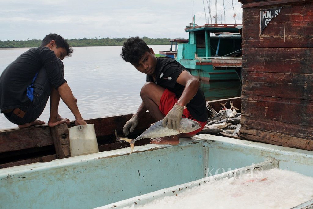 Dua nelayan di Kecamatan Bunguran Timur, Natuna, Kepulauan Riau, menyiapkan umpan untuk melaut, Minggu (12/1/2020). 