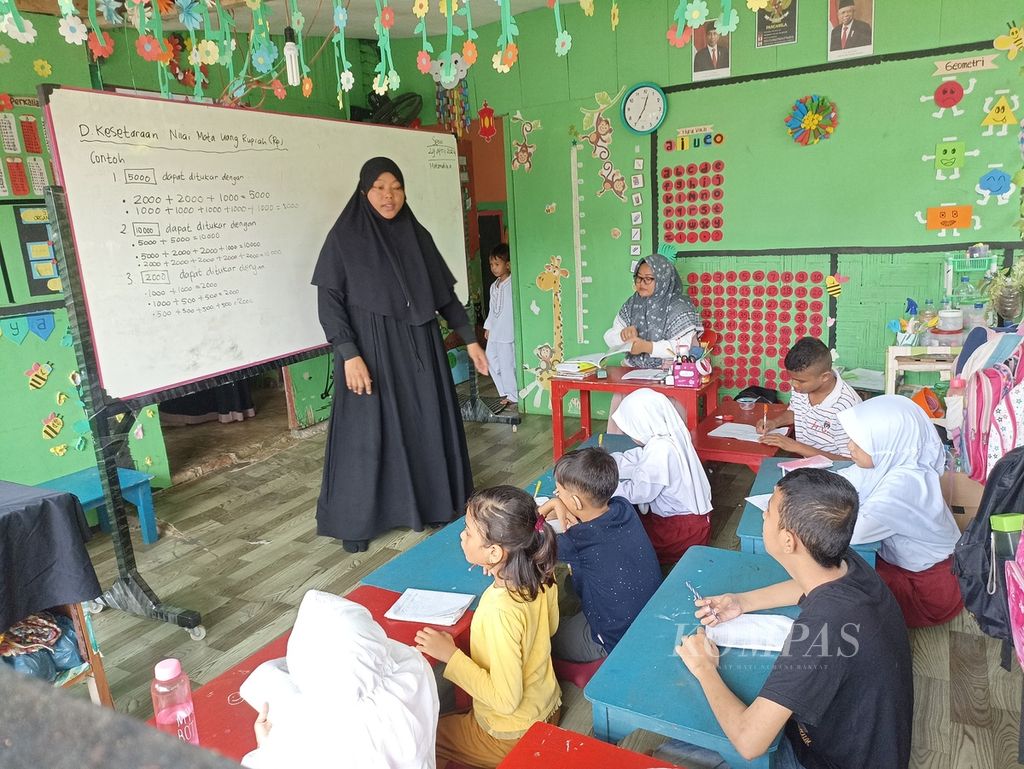 Yuli Yanika (kiri) mengajar di sekolah inklusi setara SD di Yayasan Rumah Ceria Medan, Sumatera Utara, Senin (29/4/2024).