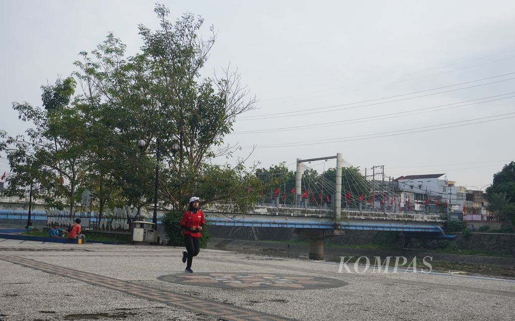 Warga berlari di kawasan Banjir Kanal Barat, Kelurahan Ngemplak Simongan, Kecamatan Semarang Barat, Kota Semarang, Jawa Tengah, Kamis (7/12/2023). Kawasan Banjir Kanal Barat menjadi salah satu tempat favorit bagi warga untuk berolahraga lari. 