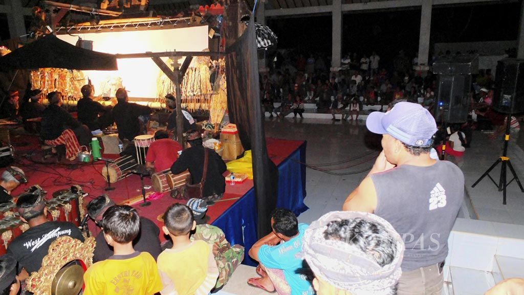 Puluhan warga pengungsi akibat erupsi Gunung Agung di Pos Pengungsian UPT Rendang, Kabupaten Karangasem, Bali, menonton pentas wayang kulit Cenk Blonk, Jumat (23/2) malam. Pentas tersebut merupakan bagian dari upaya sosialisasi dan edukasi kesiapsiagaan bagi warga  menghadapi bencana.