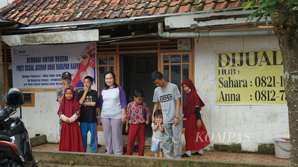 Mahnidar (ketiga dari kiri) pengelola panti Asuhan Anak Harapan Karya, Palembang, Sumatera Selatan, bersama dengan ketujuh anak panti, Kamis (27/10/2022). Dia berupaya keras agar anak asuhnya bisa terus bersekolah walau terbatas dana.