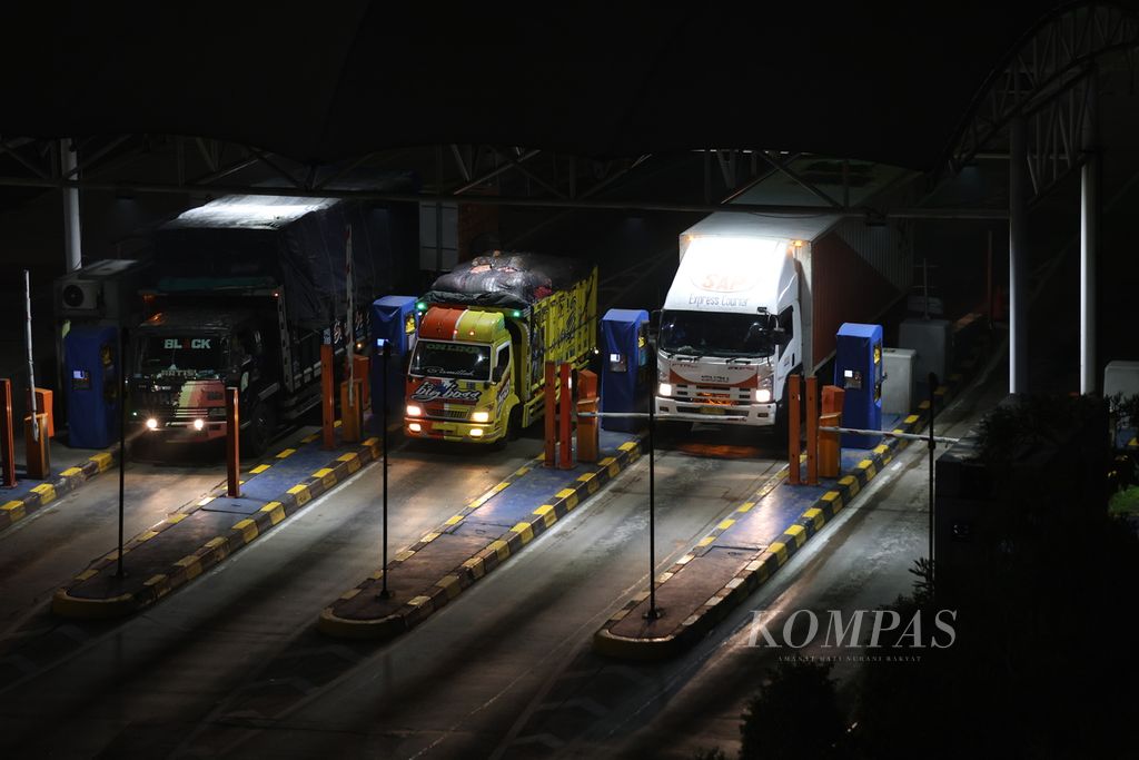 Deretan truk melakukan pembayaran di Gerbang Tol Cikampek Utama, Karawang, Jawa Barat, Jumat (22/12/2023). 