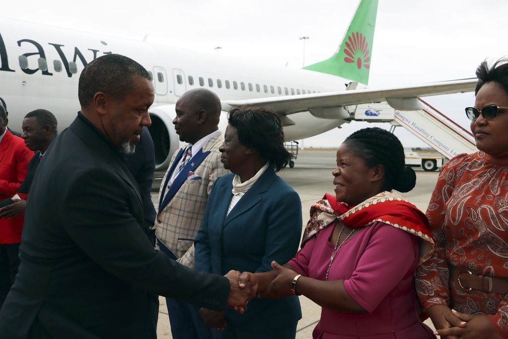 Wakil Presiden Malawi, Saulos Klaus Chilima, menjabat tangan pejabat yang menyambutnya di Lilongwe seusai menggelar kunjungan resmi ke Korea Selatan, Minggu (9/6/2024).