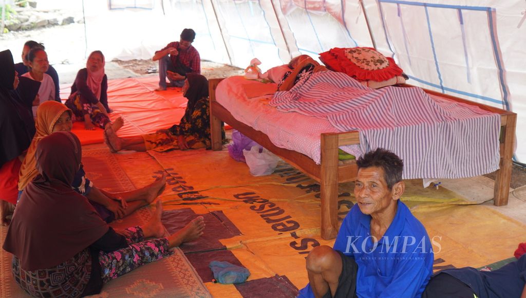 Sejumlah warga tengah beristirahat di tenda yang didirikan di halaman rumah warga di Desa Pacarejo, Kecamatan Semanu, Kabupaten Gunungkidul, Daerah Istimewa Yogyakarta, Sabtu (1/7/2023). Para warga itu mendirikan tenda akibat rumah mereka rusak karena guncangan gempa berkekuatan M 6,0, Jumat (30/6/2023) malam. 
