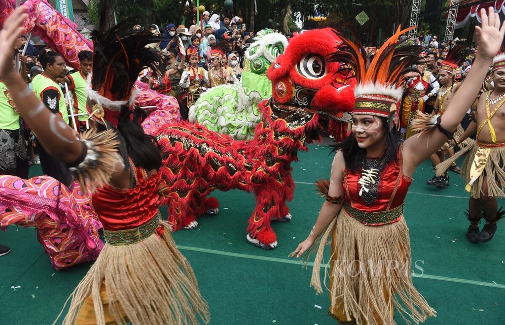 Pemain liong berkolaborasi dengan penari sajojo saat Karnaval Nusantara dalam rangka Satu Abad Nahdlatul Ulama (NU) di Alun-alun Sidoarjo, Jawa Timur, Selasa (7/2/2023). Karnaval menghadirkan beragam tarian dari Tanah Air dan dunia. Kegiatan itu mengajak masyarakat untuk menghormati budaya yang berbeda, yang menjadi ciri khas NU. 