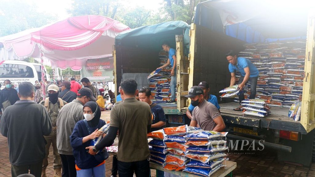 Petugas melayani pembelian beras premium dari Bulog dalam kegiatan operasi pasar barang kebutuhan pokok di Banjarmasin, Kalimantan Selatan, Sabtu (28/1/2023). Di lokasi operasi pasar, beras premium seharga Rp 60.000 dijual Rp 42.500 per sak kemasan 5 kilogram. 