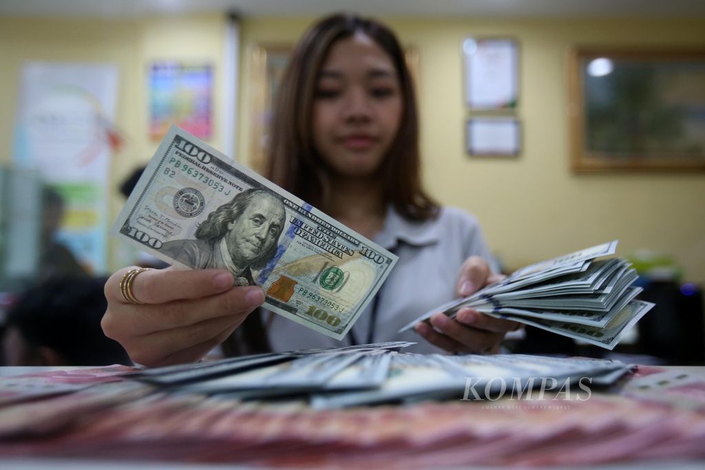 Pegawai memeriksa uang dollar AS di tempat penukaran valuta asing Dolarindo di kawasan Blok M, Jakarta Selatan, Jumat (21/6/2024). Berdasarkan kurs referensi Jakarta Interbank Spot Dollar Rate Bank Indonesia, nilai tukar rupiah pada hari Jumat senilai Rp 16.458 per dollar AS, melemah 38 poin dari hari sebelumnya.