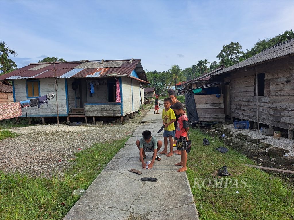 Anak-anak menyusun kertas untuk main tabang, permainan tradisional, di Dusun Sinaka, Desa Sinaka, Kecamatan Pagai Selatan, Kepulauan Mentawai, Sumatera Barat, Kamis (15/6/2023).