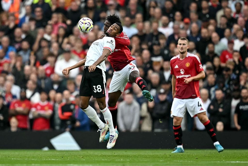 Gelandang jangkar Liverpool, Ryan Gravenberch (kiri), berebut bola dengan gelandang Manchester United, Kobbie Mainoo, pada laga Liga Inggris di Stadion Old Trafford, Manchester, Inggris, Minggu (1/9/2024). Liverpool menang 3-0.