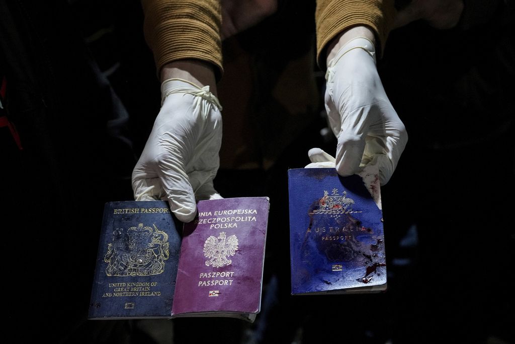 Seorang petugas memperlihatkan paspor milik sukarelawan World Central Kitchen yang terbunuh dalam serangan udara Israel di Deir al-Balah, Jalur Gaza, Senin (1/4/2024).  