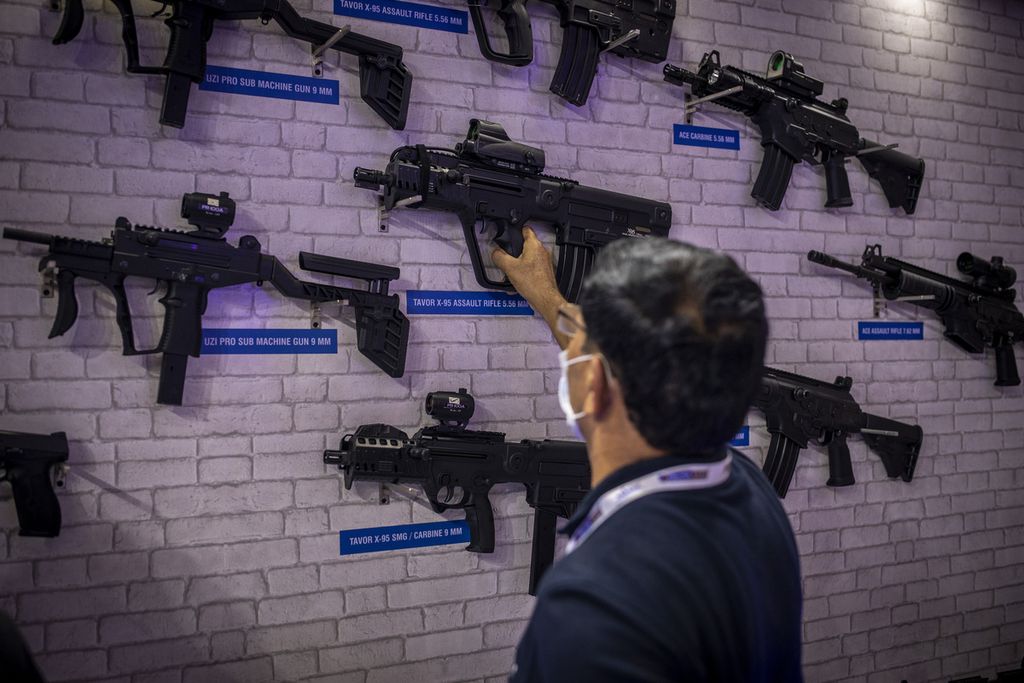 Seorang karyawan menata senapan yang diproduksi PLR Systems Private Limited, perusahaan patungan antara Grup Adani dan Israel Weapon Industries (IWI), Israel, pada ajang the International Police Expo 2021 di New Delhi, India, 18 Agustus 2021. 