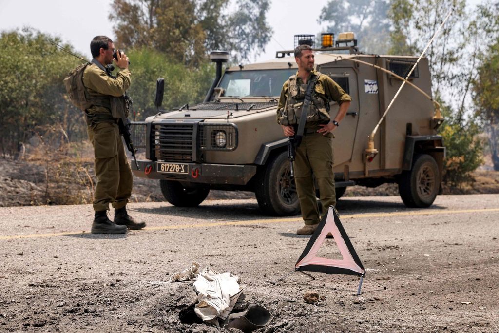 Tentara Israel diterjunkan ke sebuah ruas jalan di dekat Kfar Szold, Galilee, Israel utara, yang dihantam roket dari Lebanon selatan, 14 Juni 2024. 