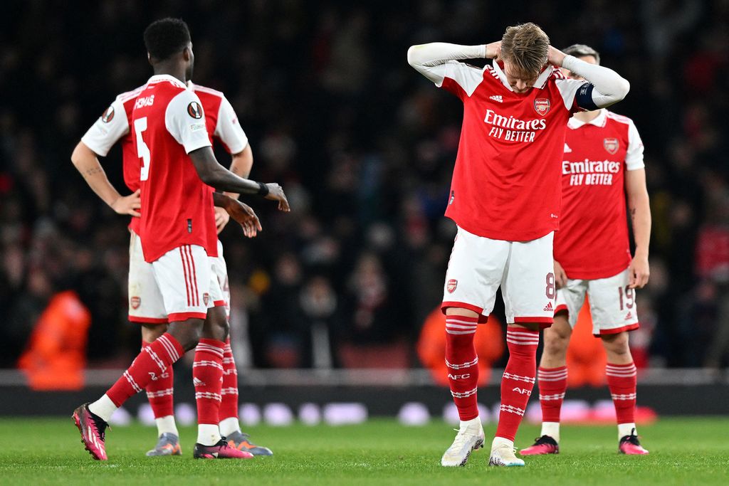 Reaksi gelandang Arsenal, Martin Odegaard (kedua dari kanan) dan rekan setimnya setelah adu penalti pada laga kedua babak 16 besar Liga Europa di Stadion Emirates, London, Jumat (17/3/2023) dini hari WIB. 
