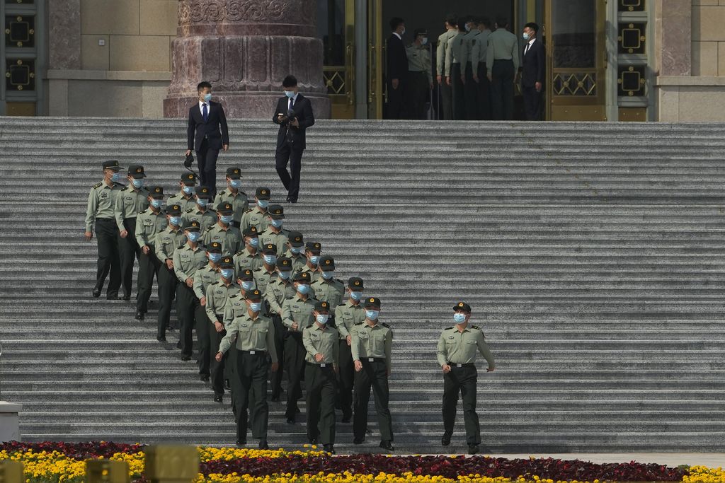 Tentara mengenakan masker saat berjalan menuruni tangga di Balai Agung Rakyat di Beijing, China, 26 September 2022, menjelang Kongres Nasional Ke-20 Partai Komunis. 