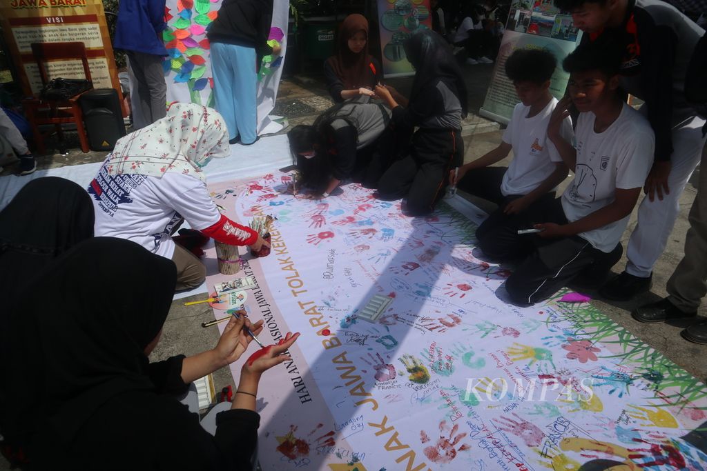 Sejumlah anak membubuhkan tanda tangan di spanduk kampanye stop kekerasan terhadap anak dalam Peringatan Hari Anak Nasional tingkat Jawa Barat di Kabupaten Kuningan, Kamis (28/7/2022).