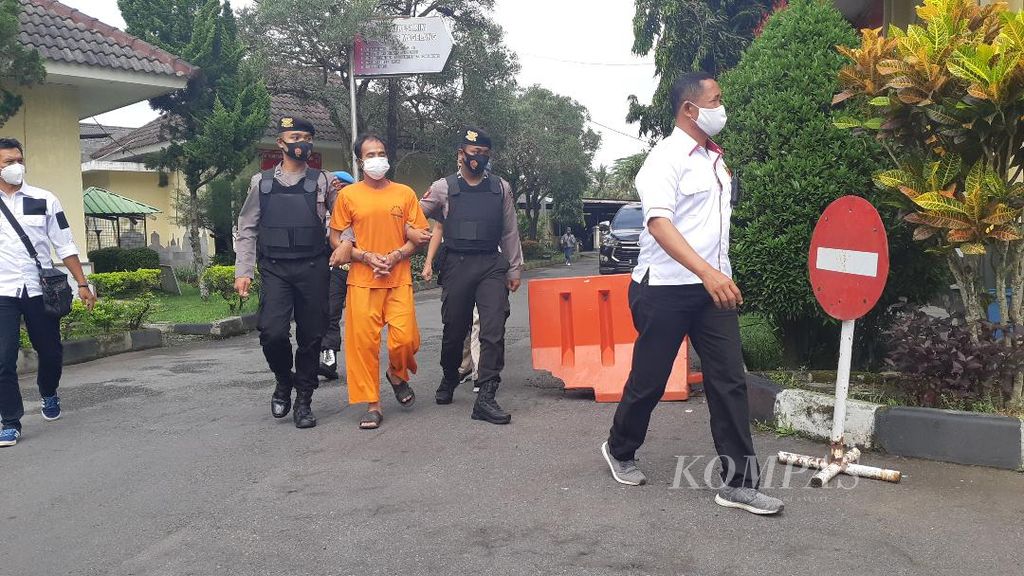 MB (42) berbaju oranye, pelaku pembunuhan berencana terhadap korban Riyanti (48), digiring oleh jajaran personel Polres Magelang, untuk dimintai keterangan, Rabu (9/3/2022).