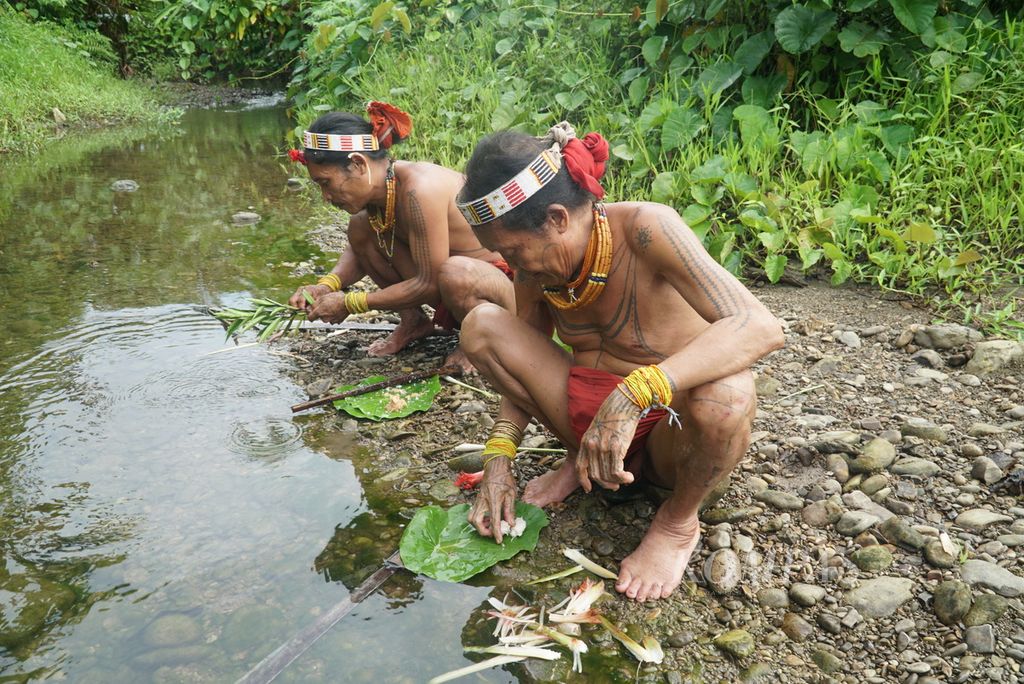 Dua sikerei, Aman Laulau (kanan) dan anaknya, Aman Lepon, sedang meramu obat di Dusun Buttui, Desa Madobag, Kecamatan Siberut Selatan, Kepulauan Mentawai, Sumatera Barat, Kamis (28/7/2022). Ahli obat tradisional Mentawai ini mengobati warga dengan mengambil dan meramu tumbuh-tumbuhan obat dari hutan.
