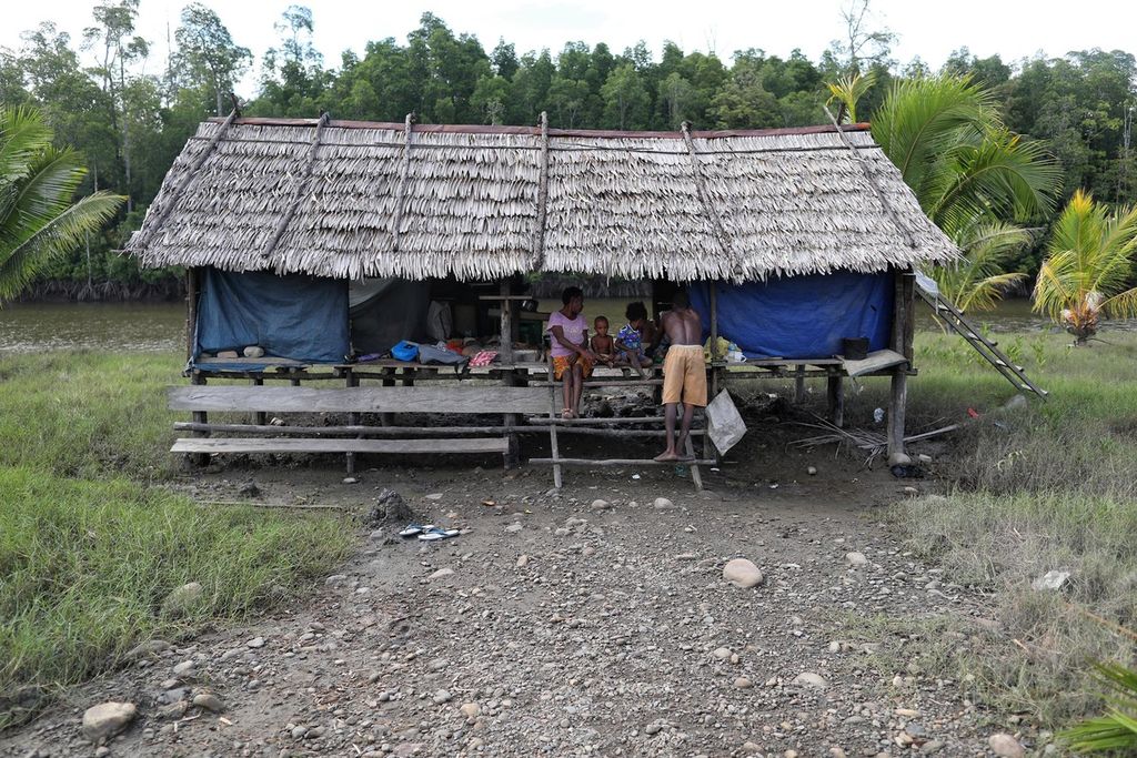 Emiliana (left, 62) lives in a hut that she built in her former village which is currently razed to waste sand, stone and mine waste because it has become one of the tailings waste disposal routes.