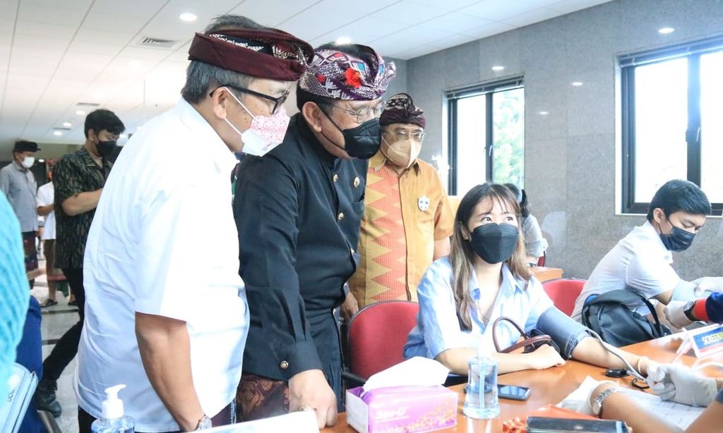 Wakil Gubernur Bali Tjokorda Oka Artha Ardana Sukawati (tengah) bersama Kepala Kantor Perwakilan BI Bali Trisno Nugroho (kiri) ketika meninjau pelaksanaan program vaksinasi penguat bagi kalangan pegawai perbankan dan keluarga pegawai perbankan di Bali, di Kota Denpasar, Kamis (20/1/2022). Pemberian vaksinasi Covid-19 dosis ketiga di Bali terus digulirkan dalam upaya pengendalian pandemi Covid-19. 