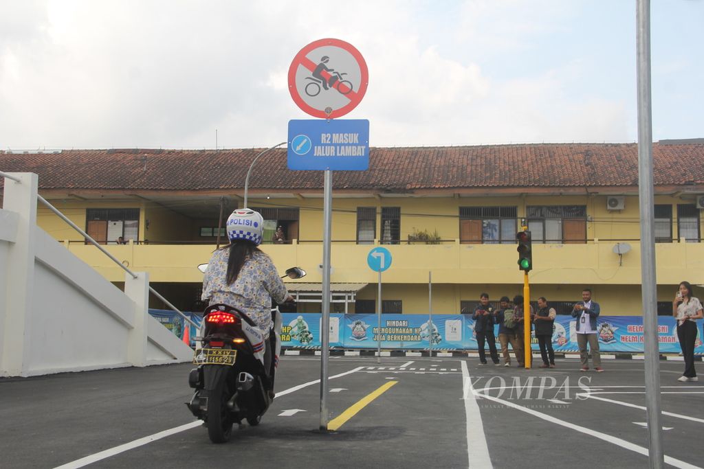 Seorang warga mengarahkan sepeda motor ke jalur lambat saat simulasi ujian praktik SIM dengan konsep baru, Senin (26/6/2023), di Markas Kepolisian Resor Bantul, Daerah Istimewa Yogyakarta. 