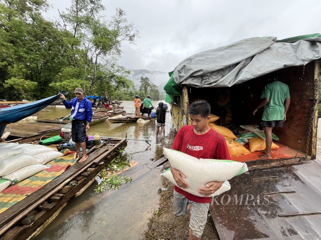 Workers lift rice onto a raft on the Trans-Sulawesi route in the district of Oheo, North Konawe, Southeast Sulawesi, which was paralyzed until Friday (10/5/2024). Hundreds of vehicles queued to pass the 700-meter-long severed route. The transportation of residents and logistics along the route that connects Southeast Sulawesi and Central Sulawesi has been hindered.