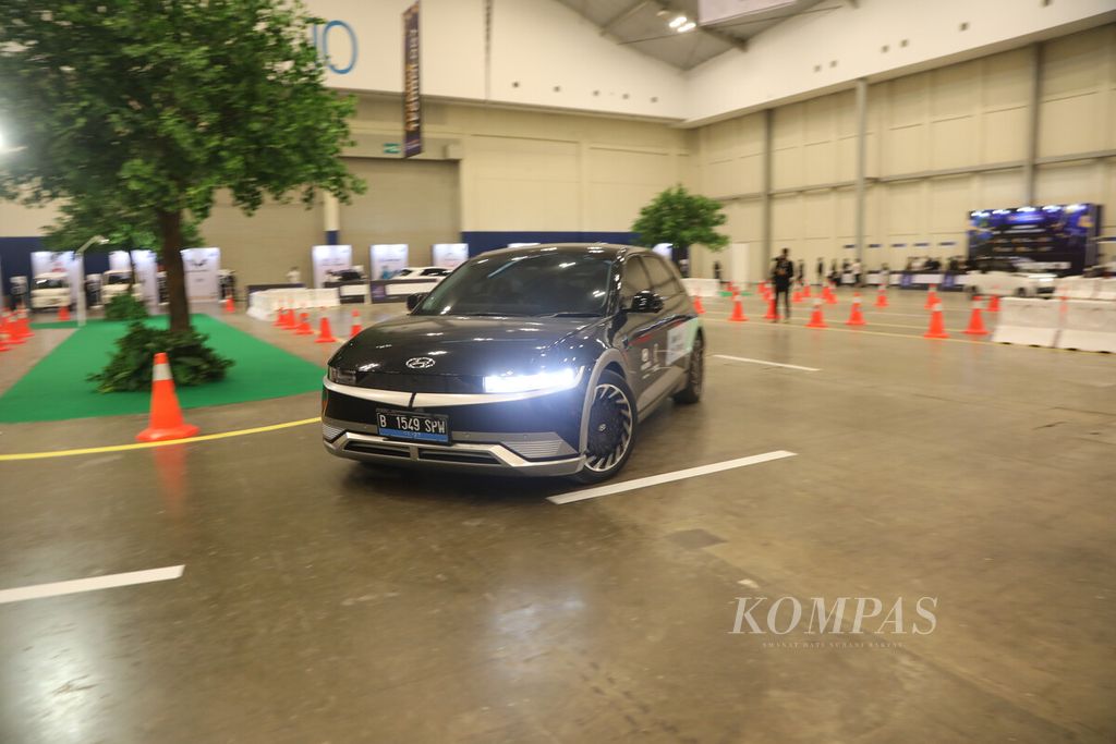 Pengunjung menguji kendara mobil listrik di arena tes dalam GIIAS 2022 di Hall 10 ICE BSD City, Tangerang, Banten, Jumat (12/8/2022). 