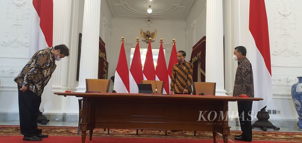 Menteri Koordinator Bidang Perekonomian Airlangga Hartarto (kiri) memberi hormat saat Presiden Joko Widodo hadir untuk mengumumkan larangan ekspor bauksit di Istana Merdeka, Jakarta, Rabu (21/12/2022). Dalam pengumuman ini, Menteri ESDM Arifin Tasrif (kanan) turut mendampingi.