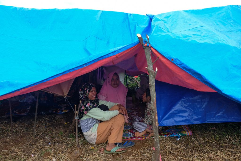 Sejumlah warga berteduh di dalam tenda pengungsian di Desa Kutawaringin, Kecamatan Mande, Kabupaten Cianjur, Rabu (30/11/2022). 