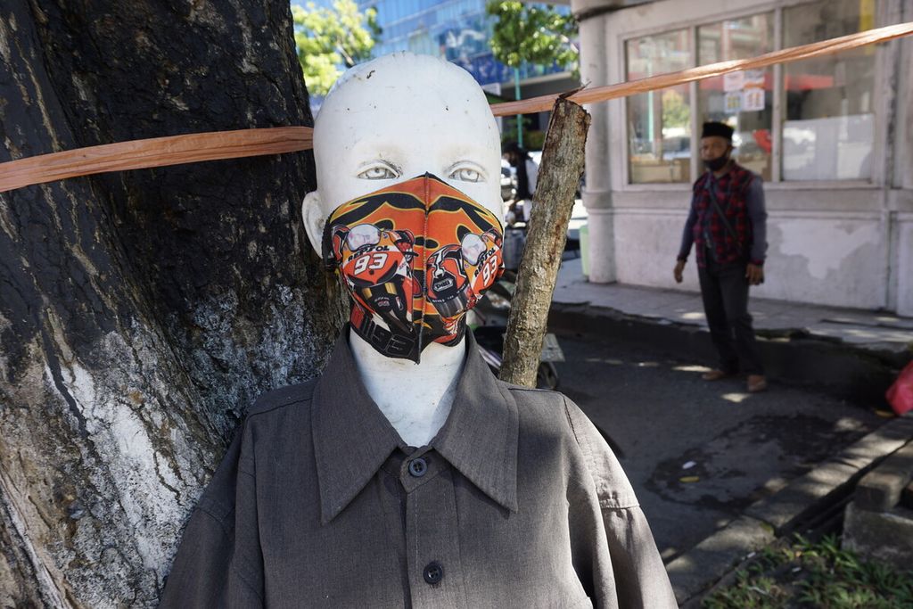 Sebuah patung dipasangi masker oleh pedagang di sekitarnya di tepi Jalan Jenderal Sudirman, Kota Balikpapan, Jumat (17/7/2020). 