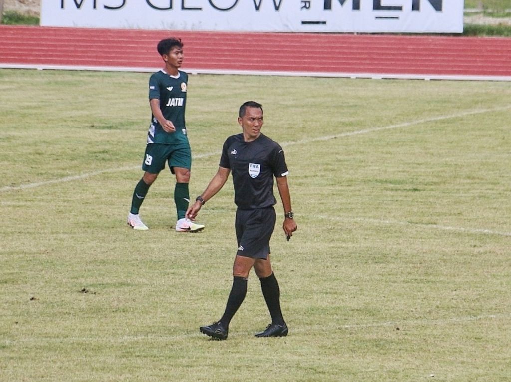 Wasit Fariq Hitaba saat memimpin laga penyisihan PON Papua 2021 antara Jawa Timur melawan Sumatera Utara, 4 Oktober lalu, di Stadion Mahacandra, Kota Jayapura. Fariq merupakan salah satu wasit berlisensi FIFA yang bertugas di Liga 1 2021-2022.
