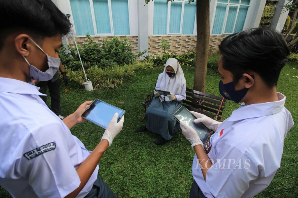 Siswa SMA Negeri 9 Kota Bandung, Jawa Barat, menggunakan tablet yang dipinjamkan sekolah, Senin (31/8/2020). Sejumlah 38.323 gawai disiapkan untuk dipinjamkan kepada siswa SMA di Jabar demi mendukung pembelajaran jarak jauh pada masa pandemi Covid-19. 