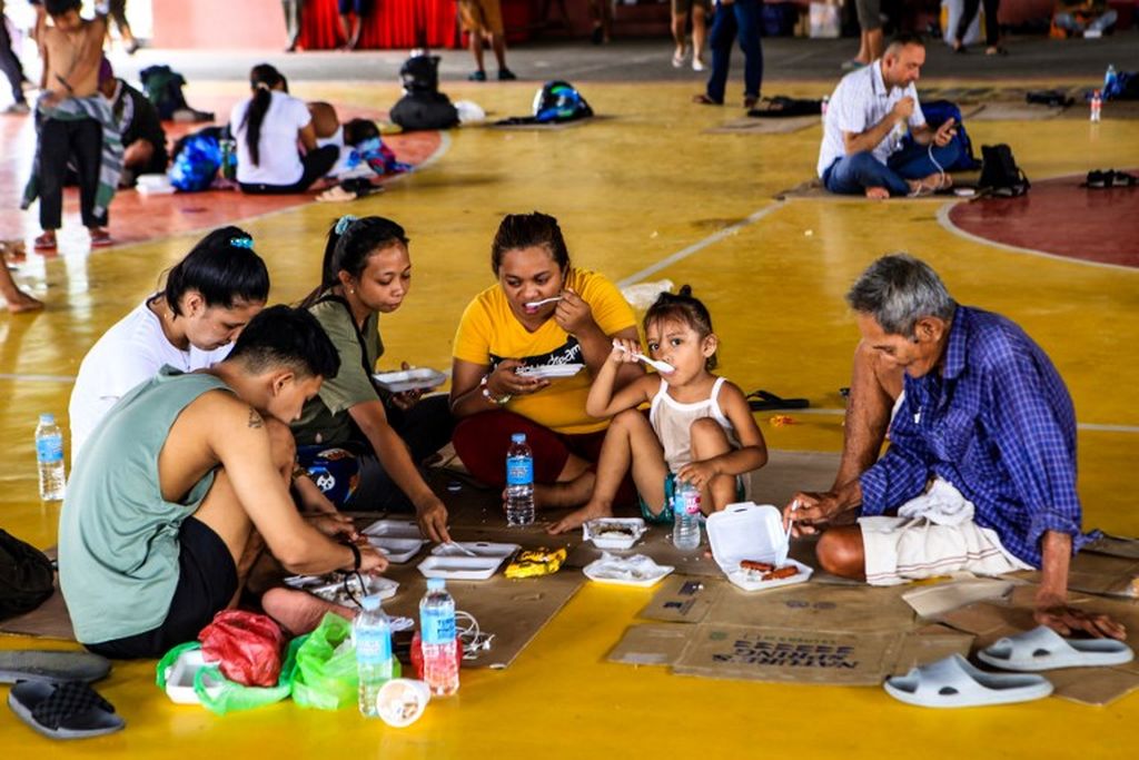 Warga yang terdampak beristirahat di dalam gimnasium di kota Matnog, Provinsi Sorsogon, Filipina, Sabtu, 28 Oktober 2022, setelah otoritas terkait menghentikan layanan feri antara Pulau Matnog di Luzon dan Allen di Pulau Samar. 
