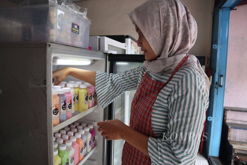 Yani Handayani (43) menata aneka produk yoghurt di tokonya, Yola Yoghurt, di Cigugur, Kabupaten Kuningan, Jawa Barat, Rabu (2/3/2022). Sejak 2012, Yani mulai membuat yoghurt dari susu sapi peternak setempat. 