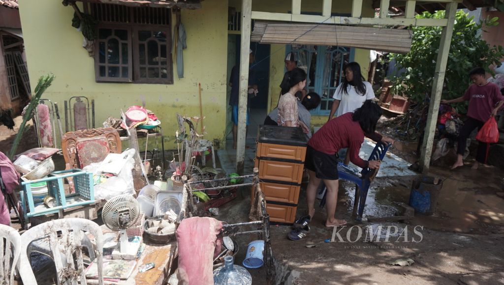 Sejumlah warga membersihkan sisa lumpur akibat banjir bandang yang menerjang dua Kelurahan di Kecamatan Teluk Betung Timur, Bandar Lampung, Selasa (31/3/2020).