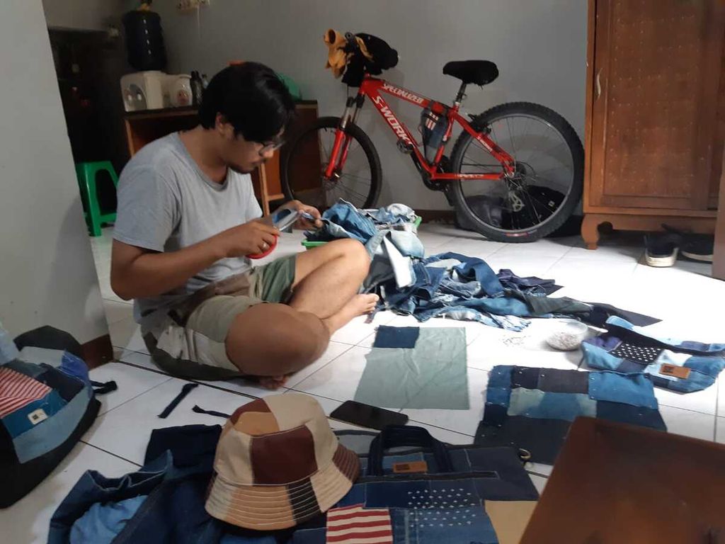 Afif Mustopha, pemilik Control New yang melakukan <i>upcycle, </i>sedang mendesain barang <i>upcycle </i>di rumahnya di Kebayoran Lama, Jakarta Selatan, Rabu (29/6/2022).