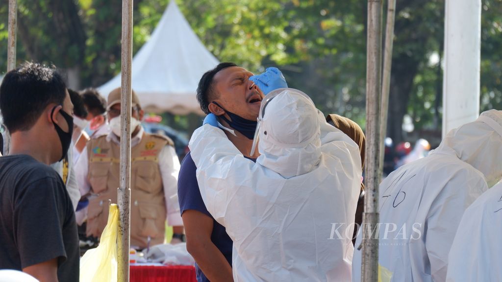 Petugas mengambil sampel <i>swab</i> atau usap hidung dan tenggorokan warga di Banjarmasin, Kalimantan Selatan, Rabu (24/6/2020).
