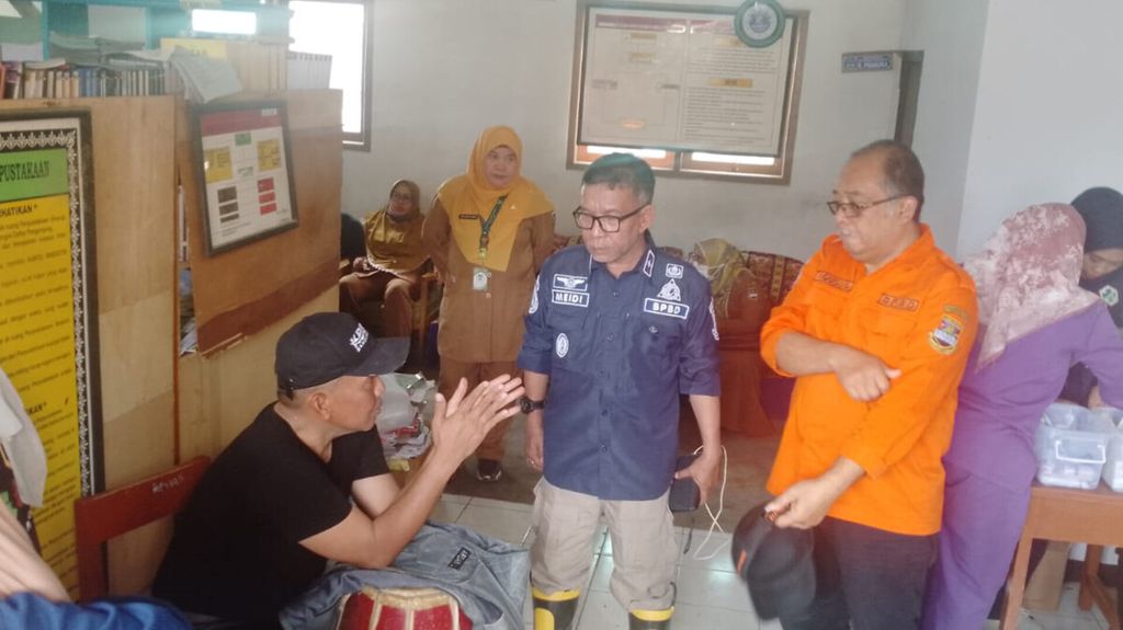 Kepala Badan Penanggulangan Bencana Daerah Bandung Barat Meidi saat meninjau para pengungsi akibat bencana longsor di Desa Cibenda, Kabupaten Bandung Barat, Senin (25/3/2024). 