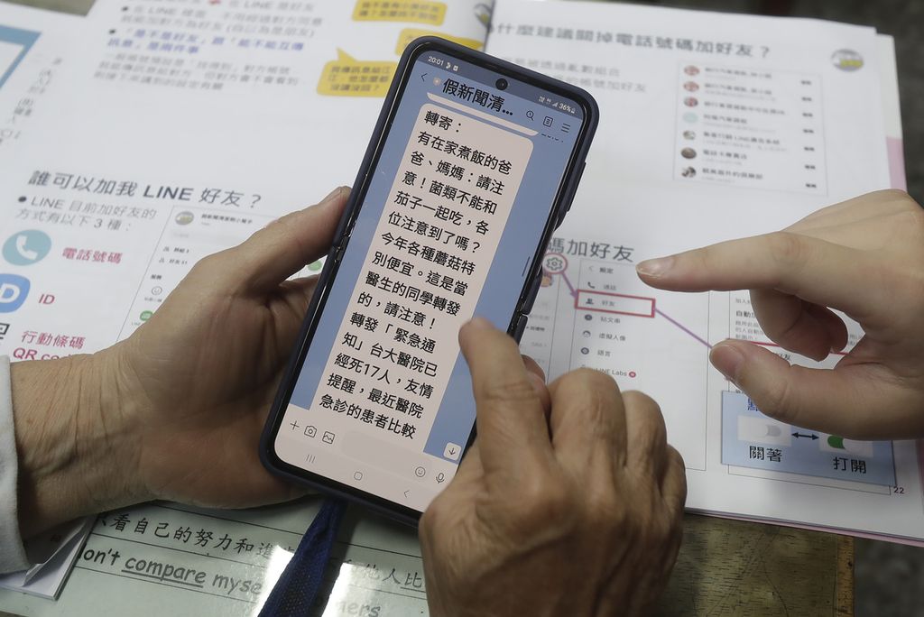 Sukarelawan Fake News Cleaner membimbing siswa melalui aplikasi Line untuk mengidentifikasi berita palsu selama kelas di kota Kaohsiung, Taiwan, 16 Maret 2023. 