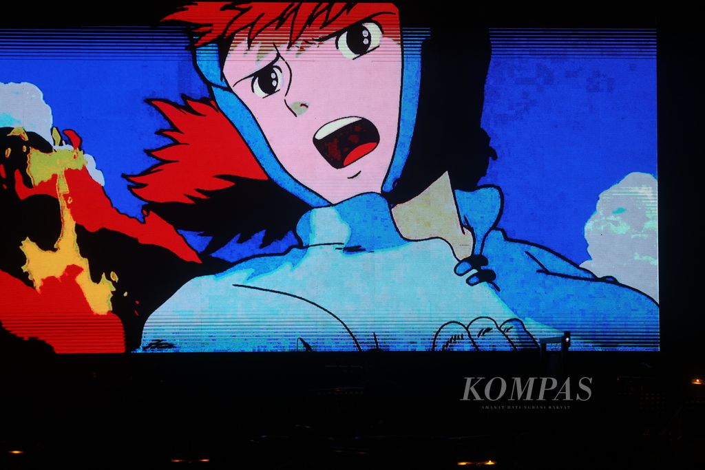 Cuplikan film animasi karya Studio Ghibli ditampilkan di awal repertoar yang dimainkan Rumah Orkestra Jogja bersiap dalam konser Saga From Our Childhood : Ghibli Chapter 02 di GOR UNY, Yogyakarta, Sabtu (9/3/2024) malam. Sedikitnya 200 musisi dari kalangan pelajar dan mahasiswa tampil membawakan sejumlah lagu dari beberapa film animasi yang diproduksi oleh Studio Ghibli, Jepang. Konser ini sebagai wadah pengembangan potensi para musisi muda Yogyakarta dalam dunia musik orkestra. Kompas/Ferganata Indra Riatmoko