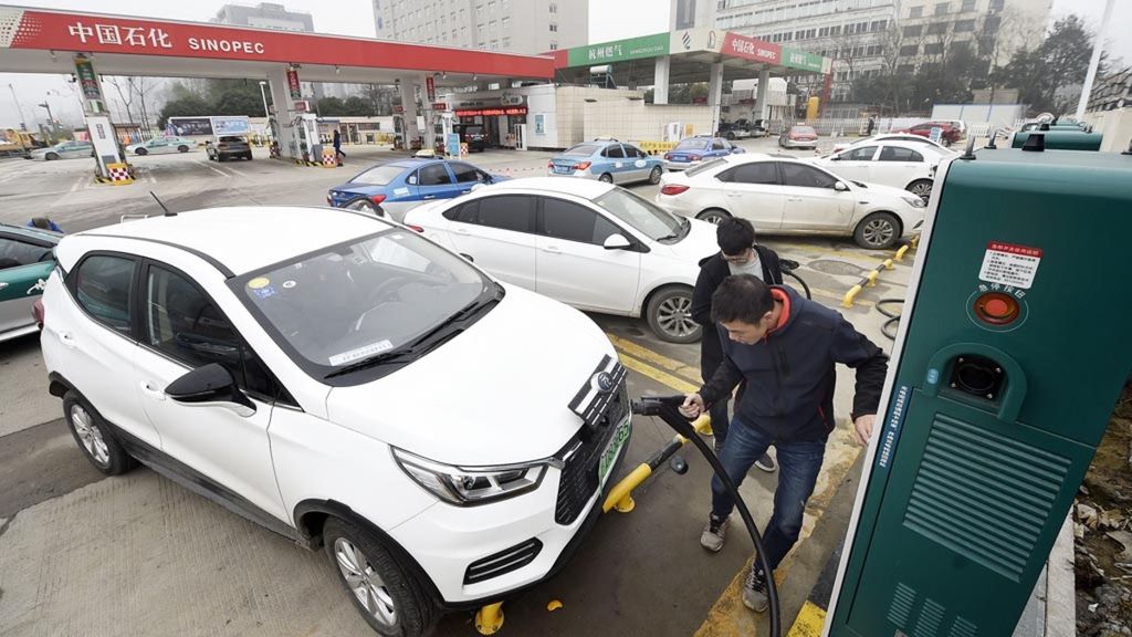 Warga mengisi daya untuk kendaraan listriknya di sebuah stasiun layanan pengisian daya di Hangzhou, Provinsi Zhejiang Timur China, Senin (14/1/2019). Stasiun pengisian ini salah satu stasiun pertama di negara ini yang menawarkan layanan pengisian bahan bakar gas alam (CNG) dan mobil listrik.