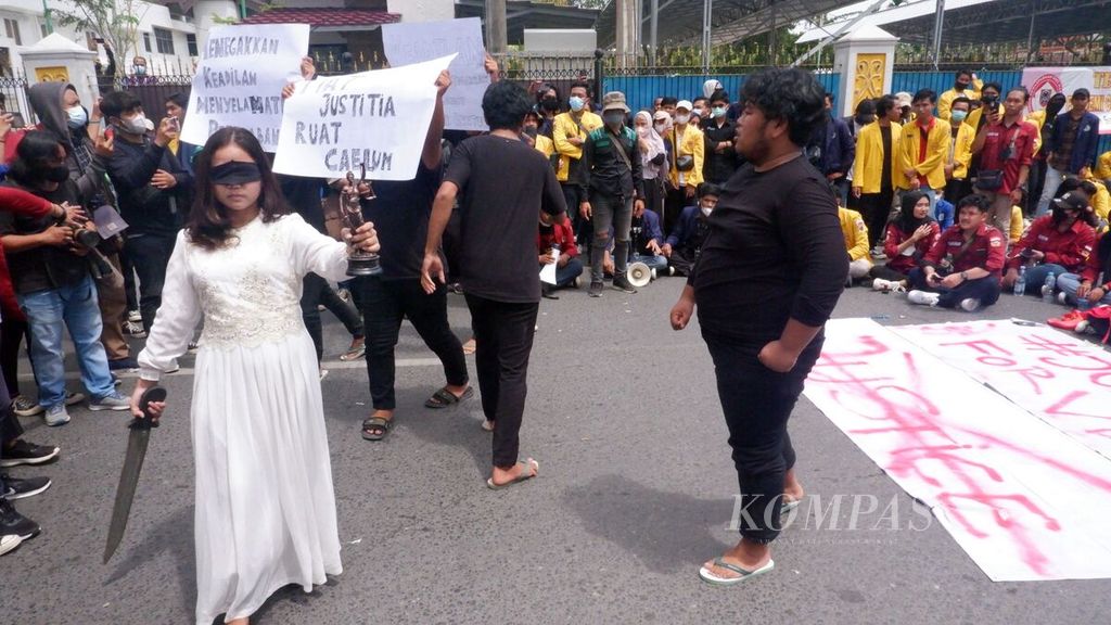 Mahasiswa Universitas Lambung Mangkurat menggelar aksi teatrikal di depan Gedung Kejaksaan Tinggi Kalimantan Selatan, di Banjarmasin, Kamis (27/1/2022). Aksi itu sebagai bentuk solidaritas mahasiswa kepada salah seorang rekan mereka yang menjadi korban pemerkosaan oknum polisi. 