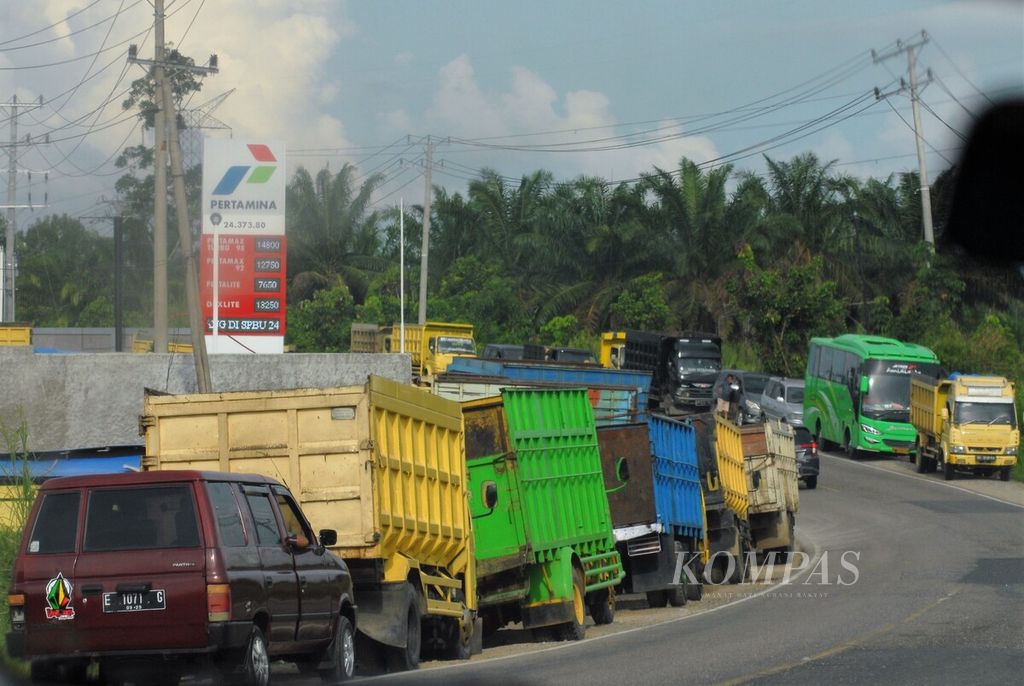 Antrean panjang angkutan batubara menuju stasiun pengisian bahan bakar umum (SPBU) memenuhi bahu jalan di Kabupaten Sarolangun, Jambi, Jumat (3/6/2022). 