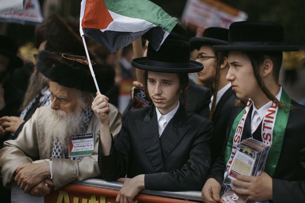 Hasidic Jews wave a flag of Palestine as they protest against Israel in front of the United Nations headquarters during the 73rd session of the United Nations General Assembly on Thursday, Sept. 27, 2018, in New York. Dozens of Hasidic Jews protest against the existence of the state of Israel and demanding the end of what they consider is the occupation of Palestine.