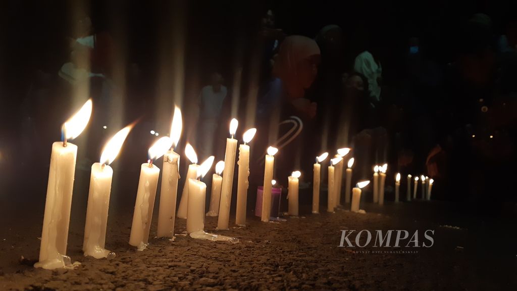 Puluhan Aremania menggelar doa bersama di sisi timur Stadion Gajayana, Malang, Jawa Timur, Minggu (2/10/2022) malam. Selain mengirim doa untuk rekan-rekannya yang telah meninggal dalam tragedi Kanjuruhan, mereka juga berharap kasus diusut tuntas dan yang bertanggung jawab atas insiden tersebut ditindak.