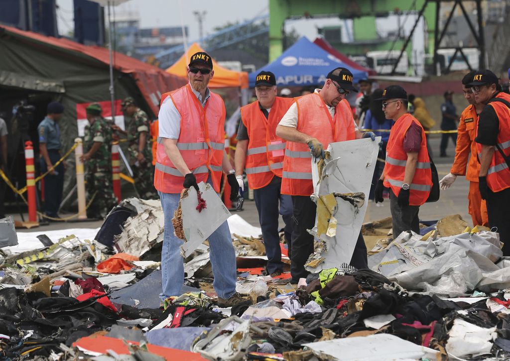 Penyelidik dari Amerika Serikat memeriksa puing-puing pesawat Lion Air JT-610 yang dikumpulkan di Pelabuhan Tanjung Priok, Jakarta, 1 November 2018. 